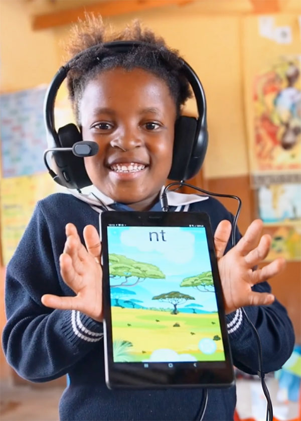 A child holding a tablet running a Readup reading assessment